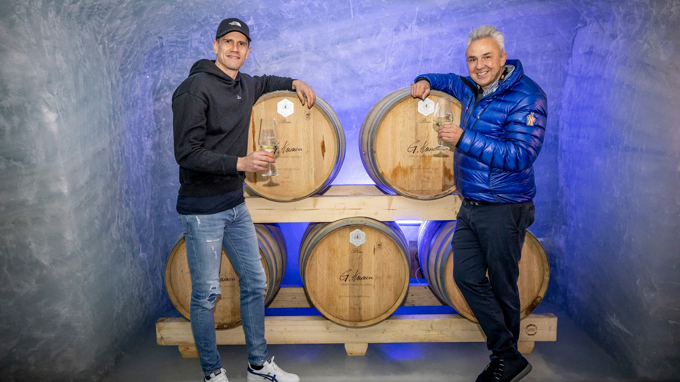 Handballstar Andy Schmid links und Jungfraubahnen Direktor Urs Kessler rechts bei der Degustation des Weins in der Eisbar